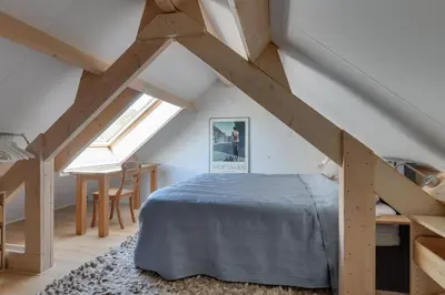 a bedroom with a bed in a attic at 't Hutje centrum Uitgeest in Uitgeest
