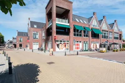 a large brick building on a city street at 't Hutje centrum Uitgeest in Uitgeest