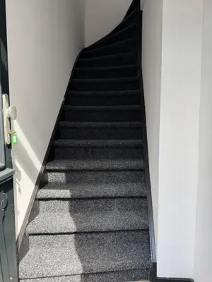 a stair case in a building with black stairs at Smile home 2, Zaanse schans and Amsterdam Appartements in Wormerveer