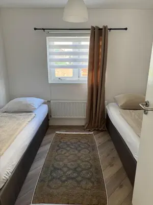 a small bedroom with two beds and a window at Smile home 2, Zaanse schans and Amsterdam Appartements in Wormerveer