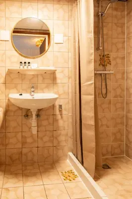 a bathroom with a sink and a shower at BadHotel Noordwijk in Noordwijk
