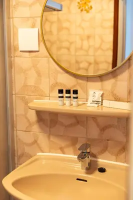 a bathroom with a sink and a mirror at BadHotel Noordwijk in Noordwijk
