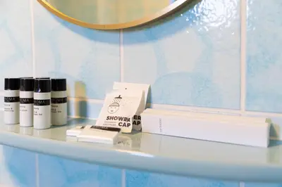 a white shelf with some products on it at BadHotel Noordwijk in Noordwijk