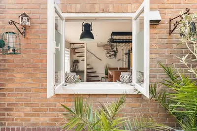 a brick wall with a window in a house at Hello Noordwijk - Quarles 43 in Noordwijk aan Zee