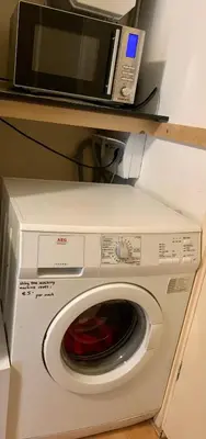 a microwave sitting on top of a washing machine at Amsterdam Edge Haven in Purmerend