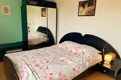 a bedroom with a bed and a mirror at Amsterdam Edge Haven in Purmerend