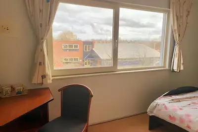a bedroom with a window and a desk and a bed at Amsterdam Edge Haven in Purmerend