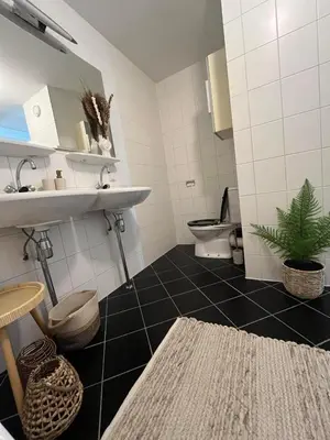 a bathroom with a sink and a toilet at A few steps away apartment in Zandvoort