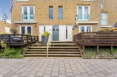a house with two wooden benches in front of it at A few steps away apartment in Zandvoort