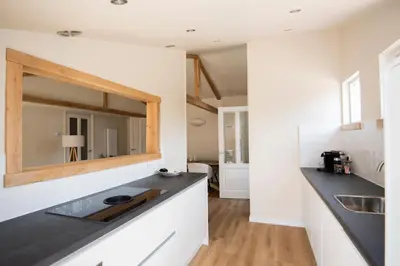 a kitchen with a sink and a mirror on the wall at Westeindercabin, rustige locatie maar naast Amsterdam & Schiphol in Aalsmeer