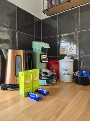a kitchen counter with a coffee maker on a table at Beach 44 in Egmond aan Zee