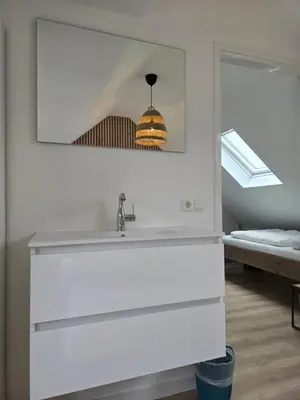 a bathroom with a sink and a mirror at Beach 44 in Egmond aan Zee