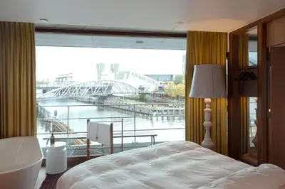a bedroom with a large window with a view of a bridge at SWEETS - Oosterdoksdraaibrug in Amsterdam