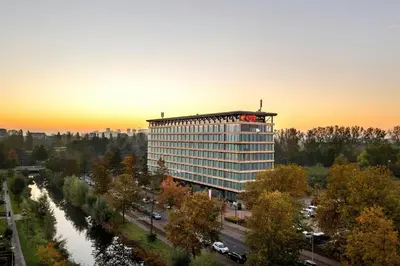 a tall building with a balcony on top of it at Corendon Amsterdam New-West, a Tribute Portfolio Hotel in Amsterdam