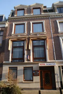 a hotel building with a hotel doorway in front of it at Hotel Domstad in Utrecht