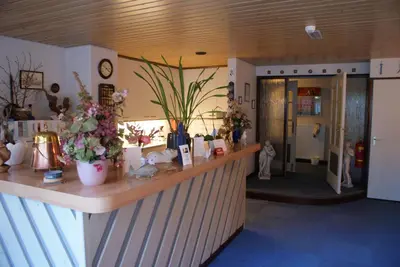 a salon with a counter with flowers on it at Hotel Domstad in Utrecht