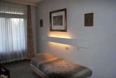 a bedroom with a bed and a picture on the wall at Hotel Domstad in Utrecht