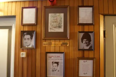 a wall with pictures of people on it at Hotel Domstad in Utrecht