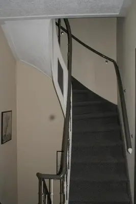 a staircase in a house with a stair railing at Hotel Domstad in Utrecht