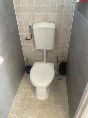 a bathroom with a white toilet in a stall at Torensduin aan zee in Egmond aan Zee