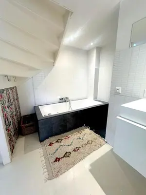 a bathroom with a sink and a bath tub at Houseboat PURE II in Vreeland
