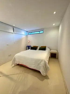 a bedroom with a large white bed with a window at Houseboat PURE II in Vreeland
