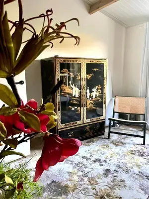a living room with a painting on the wall at Stunning Island Home with African Asian Vibe in Oude Meer