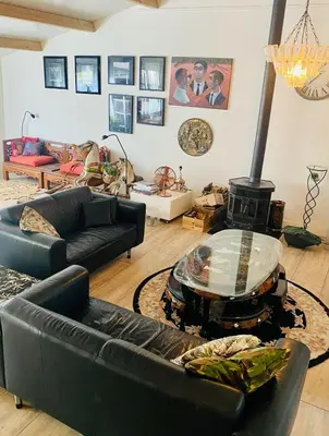a living room with a couch and a fire place at Stunning Island Home with African Asian Vibe in Oude Meer