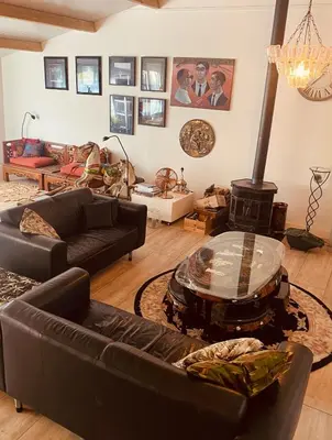 a living room with a couch and a fire place at Stunning Island Home with African Asian Vibe in Oude Meer