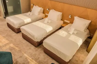 two beds in a room with white sheets and pillows at Amadi Panorama Hotel in Amsterdam