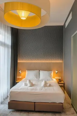 a bedroom with a bed with two stuffed animals on it at Amadi Panorama Hotel in Amsterdam