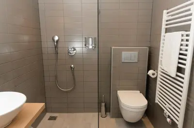 a bathroom with a shower and a toilet and a sink at Amadi Panorama Hotel in Amsterdam
