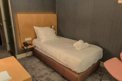 a bedroom with a bed with two towels on it at Amadi Panorama Hotel in Amsterdam