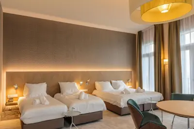 a hotel room with two beds and a table at Amadi Panorama Hotel in Amsterdam