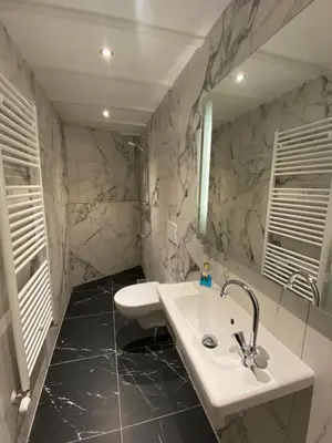 a bathroom with a sink and a mirror at Studio Bergen in Bergen