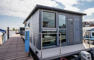 a tiny house on a dock on a boat at Havenlodge in Uitgeest