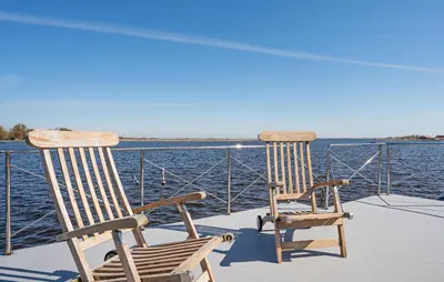 two rocking chairs sitting on the deck of a boat at Fuut Campi in Uitgeest