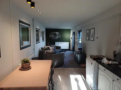 a living room with a couch and a table at Boerderij Appartement Jachtlust in Voorhout