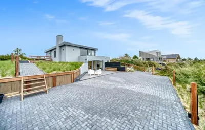 a driveway with a house and two dogs on it at Stunning Home In Bergen Aan Zee in Bergen aan Zee