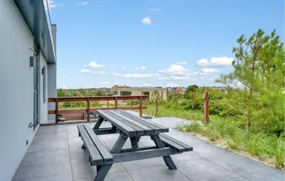 a picnic table on the balcony of a building at Stunning Home In Bergen Aan Zee in Bergen aan Zee
