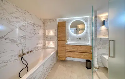 a bathroom with a tub and a sink and a mirror at Stunning Home In Bergen Aan Zee in Bergen aan Zee