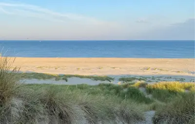 a sandy beach with the ocean in the background at Stunning Home In Bergen Aan Zee in Bergen aan Zee