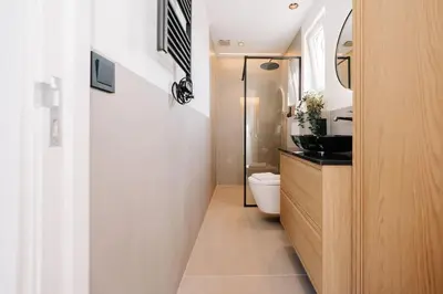 a small bathroom with a toilet and a sink at Bella Beach House in Zandvoort
