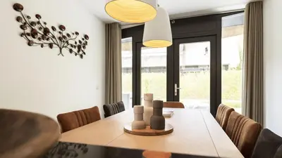 a dining room with a table and chairs at Dutchen Villapark Mooi Schoorl in Schoorl