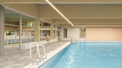 a woman is standing next to a swimming pool at Emma's Atelier in Bergen