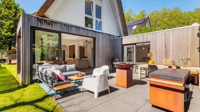 a patio with a couch and chairs and a table at Emma's Atelier in Bergen