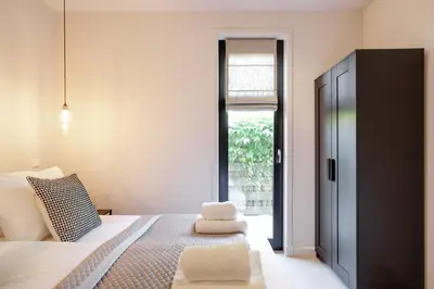 a bedroom with a bed and a large window at The Ville in Groet