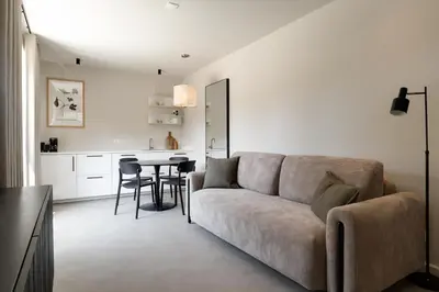 a living room with a couch and a table at The Ville in Groet
