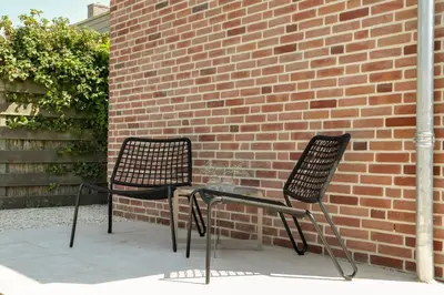 two chairs sitting next to a brick wall at The Ville in Groet