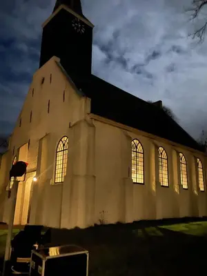 a church with its lights on in the dark at The Ville in Groet